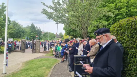Crowds of people gather in Burgess Hill to commemorate VE Day.
