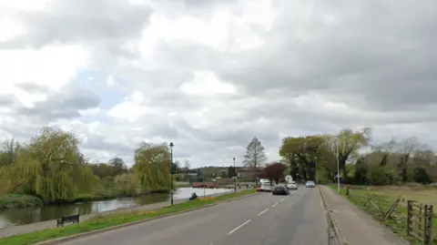 A general view of the Embankment in Wellingborough. A road passes close to the River Nene as cars can be seen travelling along it.