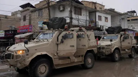 Syrian army military vehicles are deployed inside the city of Tabqa, after the withdrawal of the Syrian Democratic Forces, 18 January 2026
