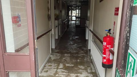 Corridor at Wollongong house, showing water on floor