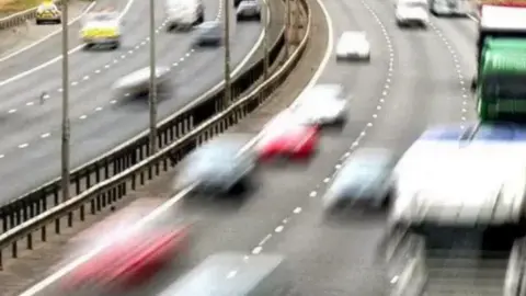 The photo shows cars travelling in both directions on a motorway