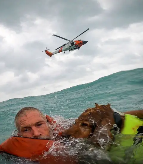 US Coast Guard/Handout via REUTERS A US Coast Guard Air Station unit  rescues a antheral   and his canine  during Hurricane Helene aft  his sailboat became disabled and started taking successful  h2o  disconnected  Sanibel Island, Florida 