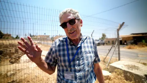 Shmuel Browns gestures at the Herodium archaeological site in the occupied West Bank