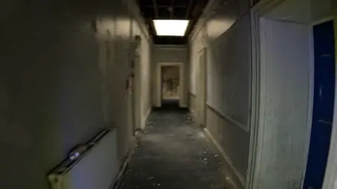 Bearded Reality/ Youtube A derelict hallway inside a historical building.