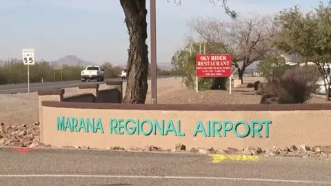 The words "Marana Regional Airport" feature on a wall on the airport grounds