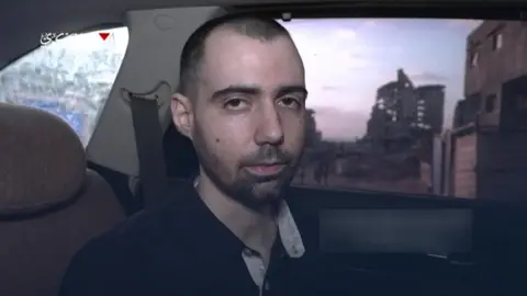 Hamas A screenshot of a video released by Hamas, showing Guy Gilboa-Dalal in the back of a car.