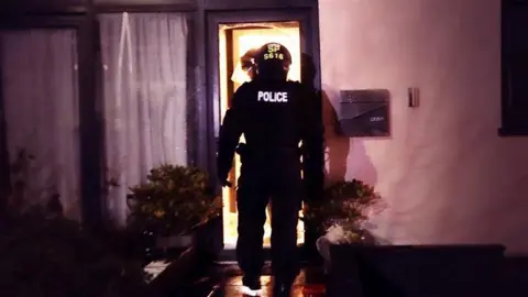 police officer entering house