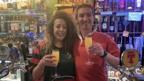 Hannah Williams Hannah and Andrew behind the bar