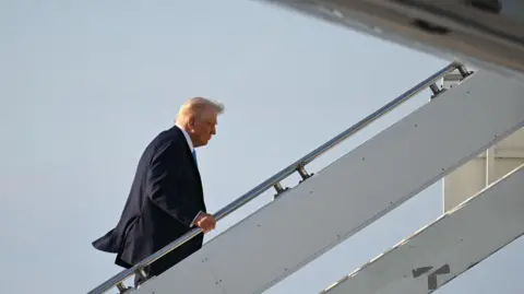 US President Donald Trump boards Air Force One at Palm Beach International Airport.