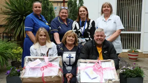 Hospital staff with the fundraisers and donated Ipads