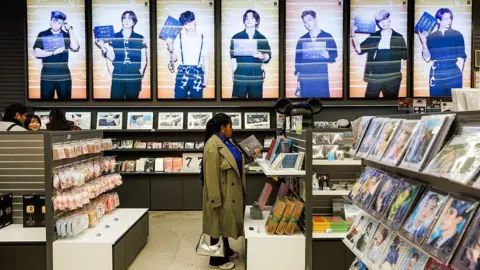 Getty Images Customers browse K-pop band BTS merchandise at a souvenir store in Seoul, South Korea, on Wednesday, March 18, 2026