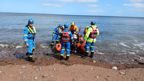 The Whitby inshore lifeboat on the beach at Saltwick Bay, near Whitby.