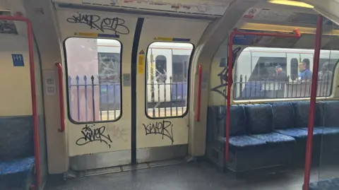 Graffiti seen on the inside of one of the Tube trains on the Central line