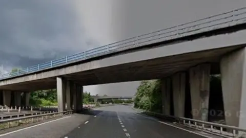 A motorway bridge over an empty M67