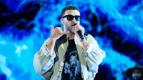 Justin Timberlake holds the mic to his mouth on stage at the Iconica Santalucia Fest