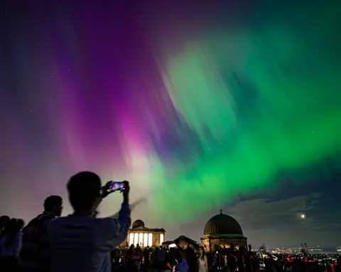 Getty Images People watch Northern Lights in Edinburgh