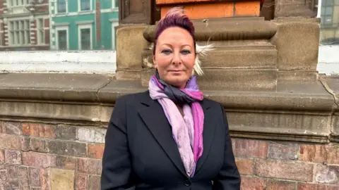 Charlotte Charles wearing a pink scarf 