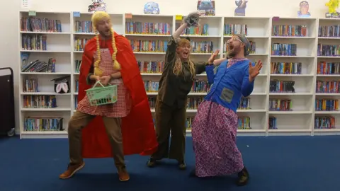 SBL Academy Three teachers dressed as the Little Red Riding Hood, a wolf and the grandma from the folklore story. 