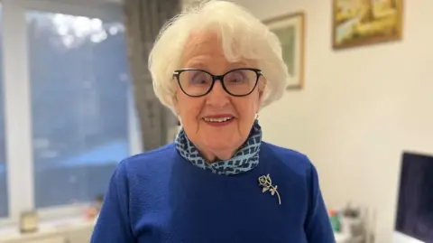 Sheila Eaton stood in her home looking at the camera.