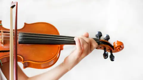 hands of a young violinist on the violin