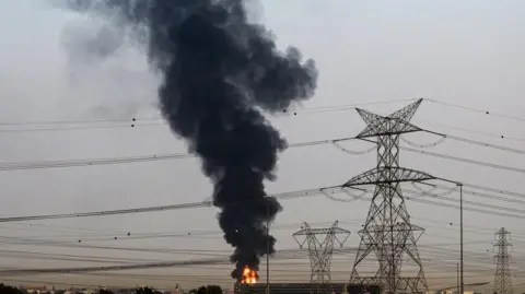 Smoke rises from an area near Dubai International Airport (DXB) in Dubai, United Arab Emirates, 16 March 2026, amid the US-Israel conflict with Iran