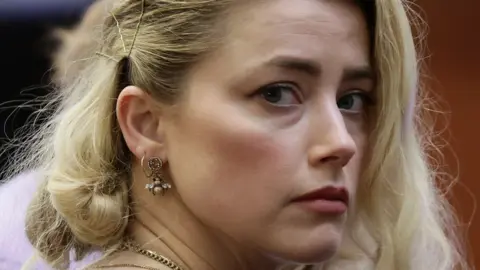 Reuters Close-up of Amber Heard looking to one side in court in 2022 