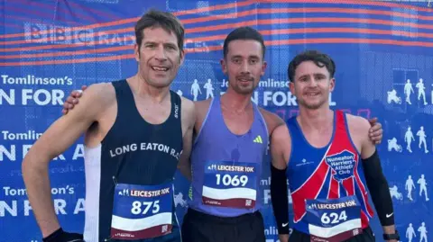 Three runners posing at the end of Leicester 10k.