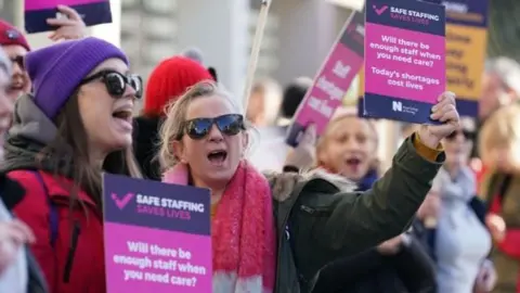 Workers on the picket line outside Royal Sussex County Hospital in Brighton during a strike by nurses and ambulance staff on 6 February 2023.