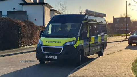 A police van parked on a residential street