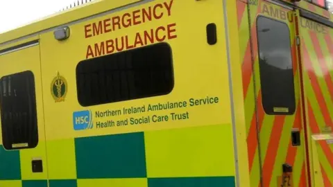 A side of a yellow ambulance 