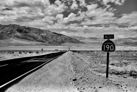 Marin Offer A road passes through a barren valley