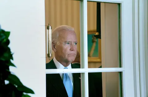 Getty Images Then-US Vice-President Joe Biden in the Oval Office on 18 September 2014