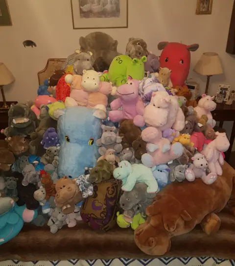 Philip Angier A huge pile of soft toys all depicting hippos in all shapes, colours and sizes.
