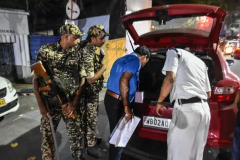 NurPhoto via Getty Images CRPF personnel along with police check vehicles ahead of assembly elections in Kolkata, India, on April 21, 2026. (Photo by Debarchan Chatterjee/NurPhoto via Getty Images)