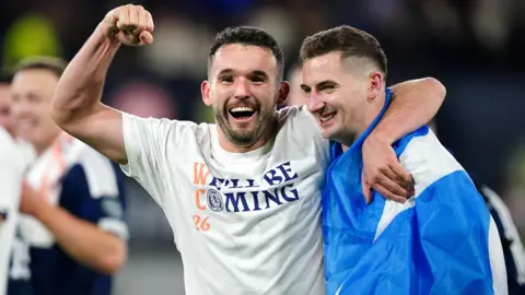 Scotland's John McGinn (left) and Kenny McLean celebrates after qualifying for the 2026 World Cup after beating Denmark 4-2 in their final qualifier at Hampden Park, Glasgow. 