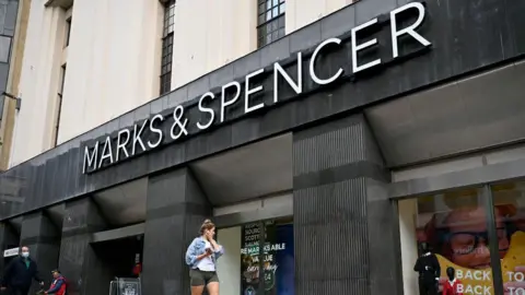 Getty Images Woman walking past M&S