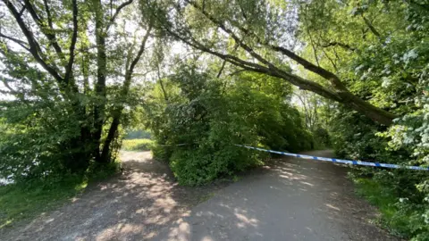 BBC Police tape across a path