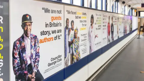 David Garcia Portraits with slogans along a wall