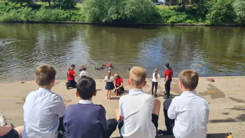 Hereford and Worcester Fire and Rescue Service Children watching a water safety demonstration