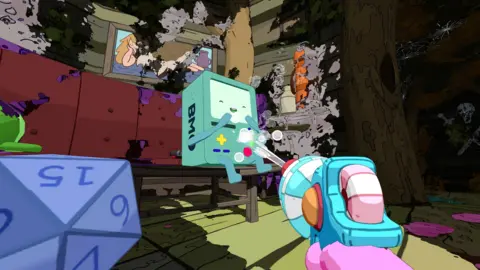 Futurlab An in-game screenshot from the game PowerWash Simulator 2. We see a first-person perspective of the player using a blue and white pressure washer to spray the robot console character BMO from Adventure Time, who is laughing. The rest of the room is covered in dirt on the walls.