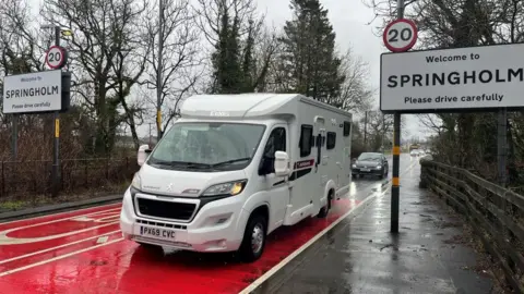 BBC White campervan driving past 20mph signs in Springholm
