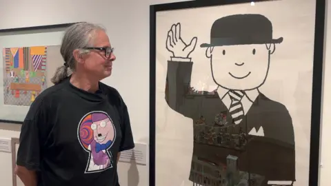 Mr Benn / David McKee Brett McKee admires a life-size image of Mr Benn