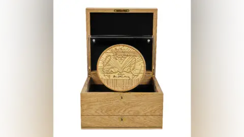 Royal Mint A gold coin with Paul McCartney's signature on, guitar and piano. Presented in a wooden box