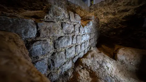 Large piece of 2,000 year old wall in an archaeological trench in an office building