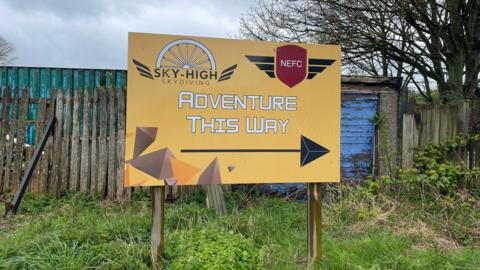 Sky High Skydiving sign reading 'Adventure this way' 