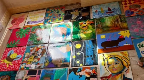 Mike Vosper Multiple paintings laid out on the floor