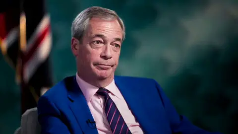 Nigel Farage during an interview with the BBC, in a light blue suit.