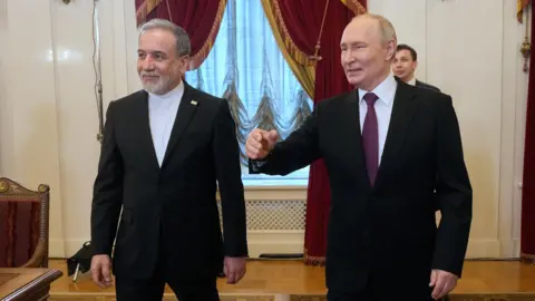 EPA Abbas Aragachi (left) and Vladimir Putin shared a photo from St Petersburg today.