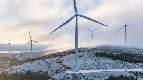 Getty Images A wind farm seen in the UK in a snowy hilly region in South Lanarkshire.