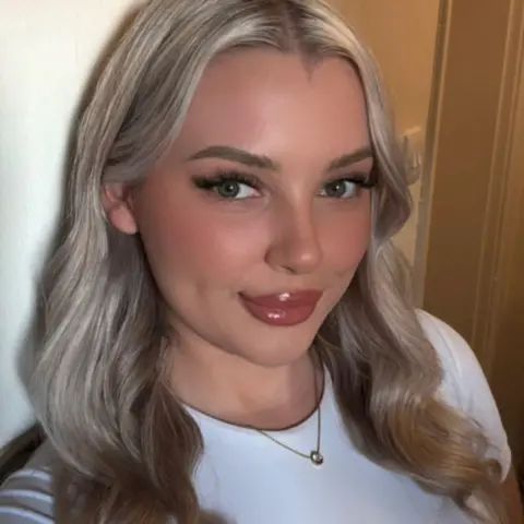 Megan Megan smiling. She is a woman with long blonde hair.